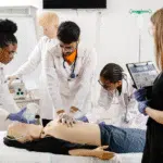 Professionnels de santé en formation AFGSU 2 pratiquant les gestes d’urgence sur mannequin lors d’un atelier de réanimation.